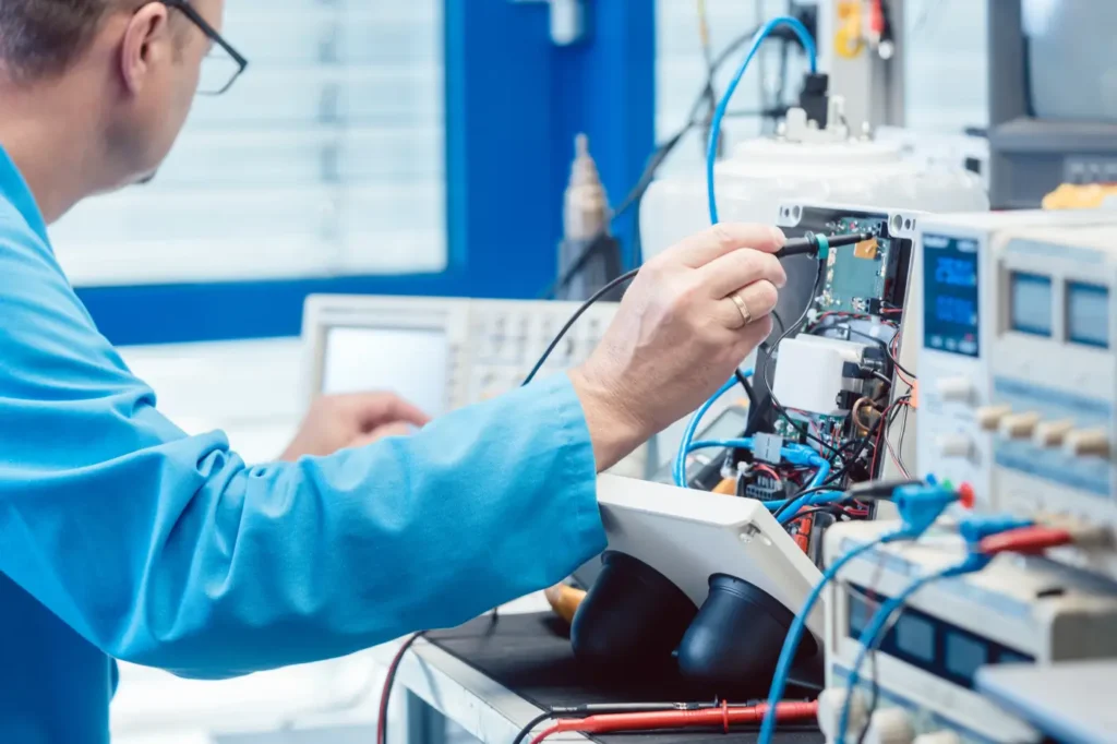 Technician probing the internal circuitry of an electronic device during CE compliance testing in an accredited lab.